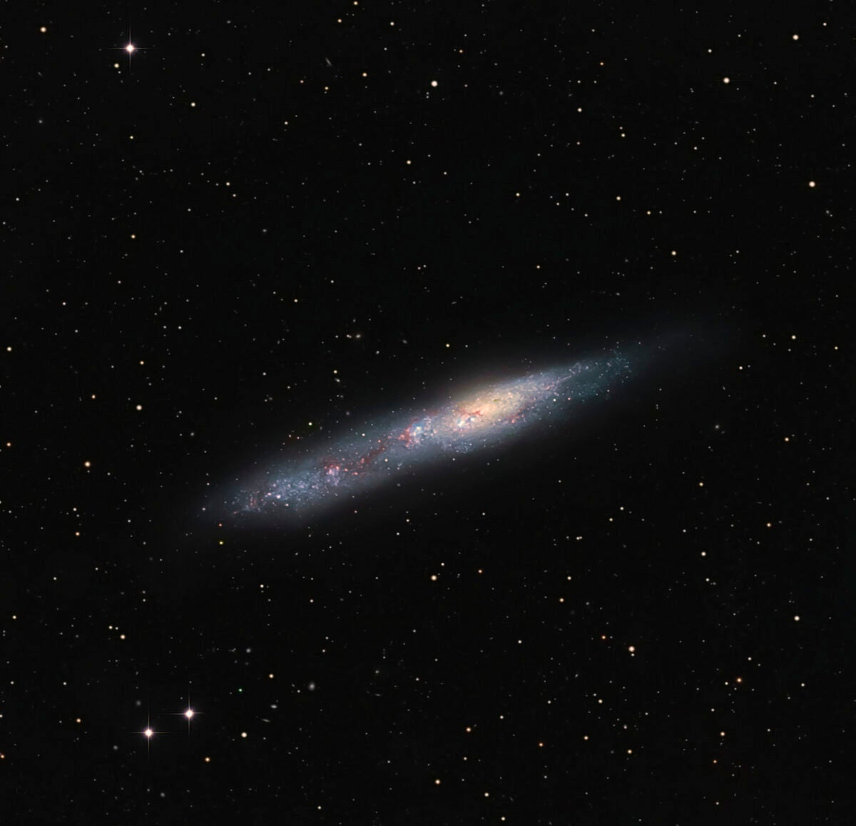 NGC 55’s oblong shape gives it an uncanny resemblances to the Cigar Galaxy (M82).