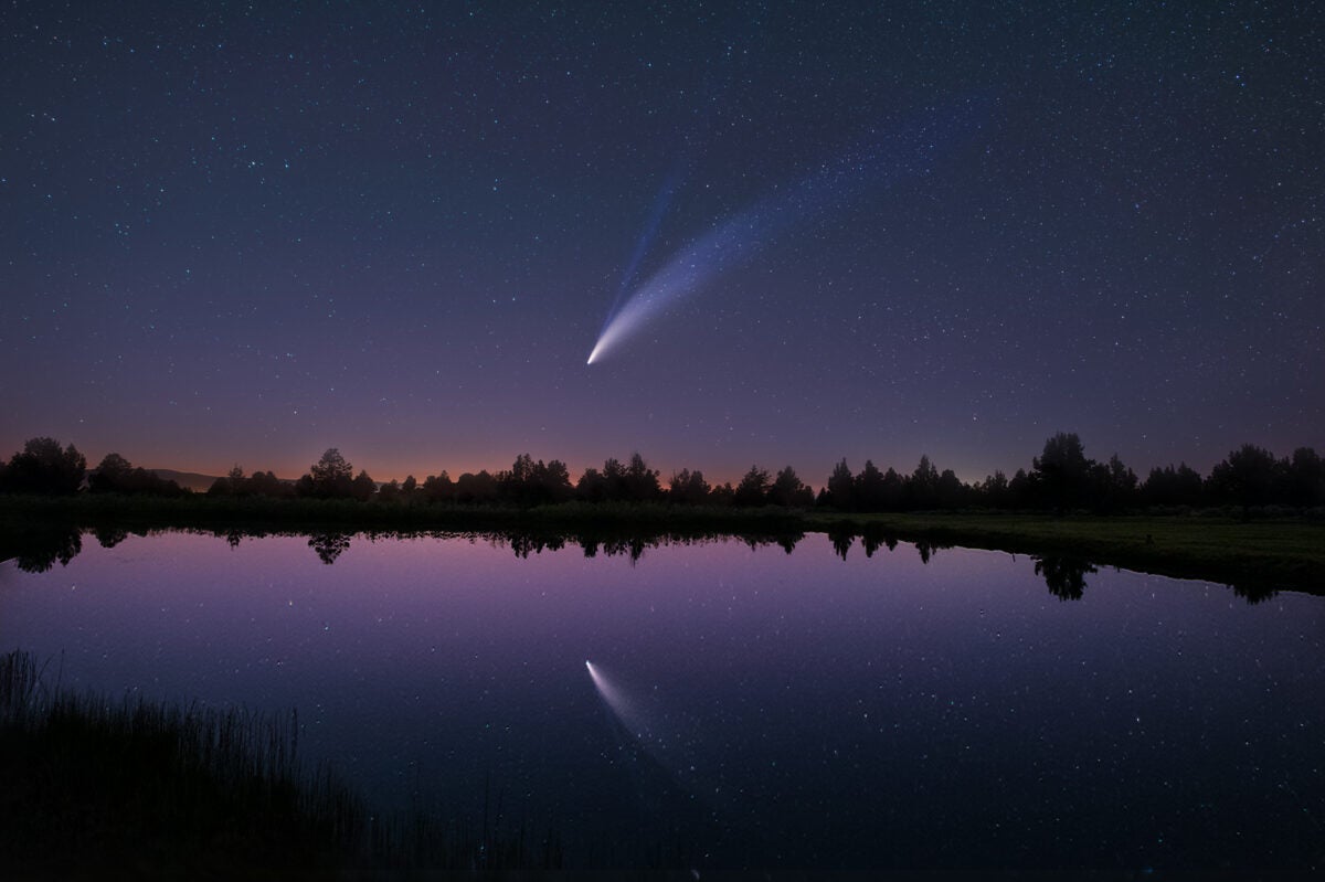 Comet C/2020 F3 (NEOWISE) gleams in the sky and waters of Modoc County, California, in this shot taken with a Samyang 24mm lens. Eight 30- second exposures were taken for the comet and one 30-second exposure was taken for the foreground.