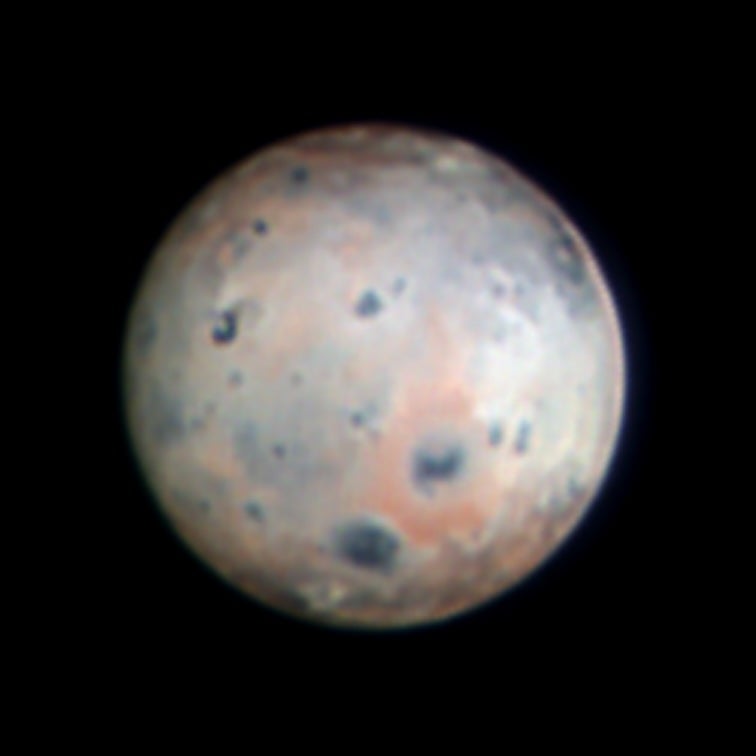 Jupiter moon Io, imaged by SHARK-VIS on Jan. 10, 2024. The image combines three spectral bands — infrared, red and yellow — to highlight the reddish ring around the volcano Pele (below and to the right of the moon's center) and the white ring around Pillan Patera, to the right of Pele. Credit: INAF/Large Binocular Telescope Observatory/Georgia State University; IRV-band observations by SHARK-VIS/F. Pedichini; processing by D. Hope, S. Jefferies, G. Li Causi.