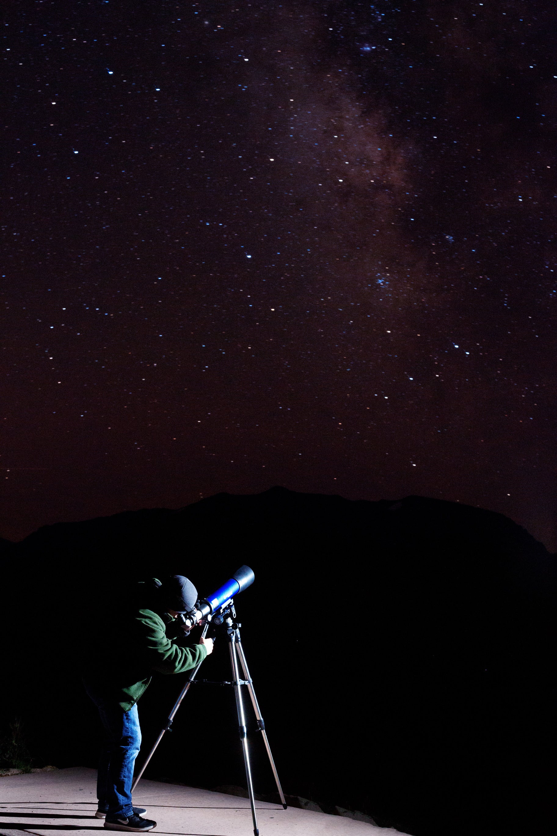 A person observing the night sky with a telescope.